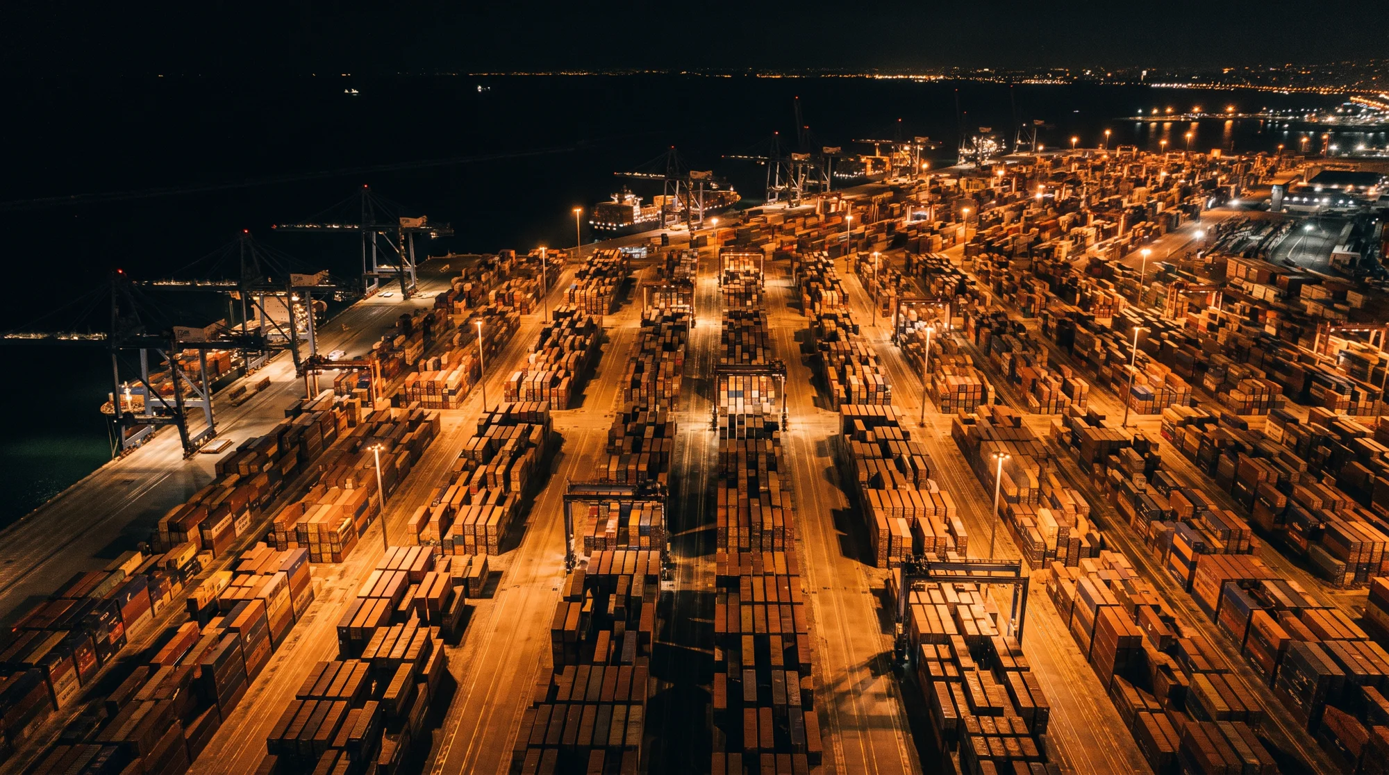 Aerial view of an illuminated container port at night
